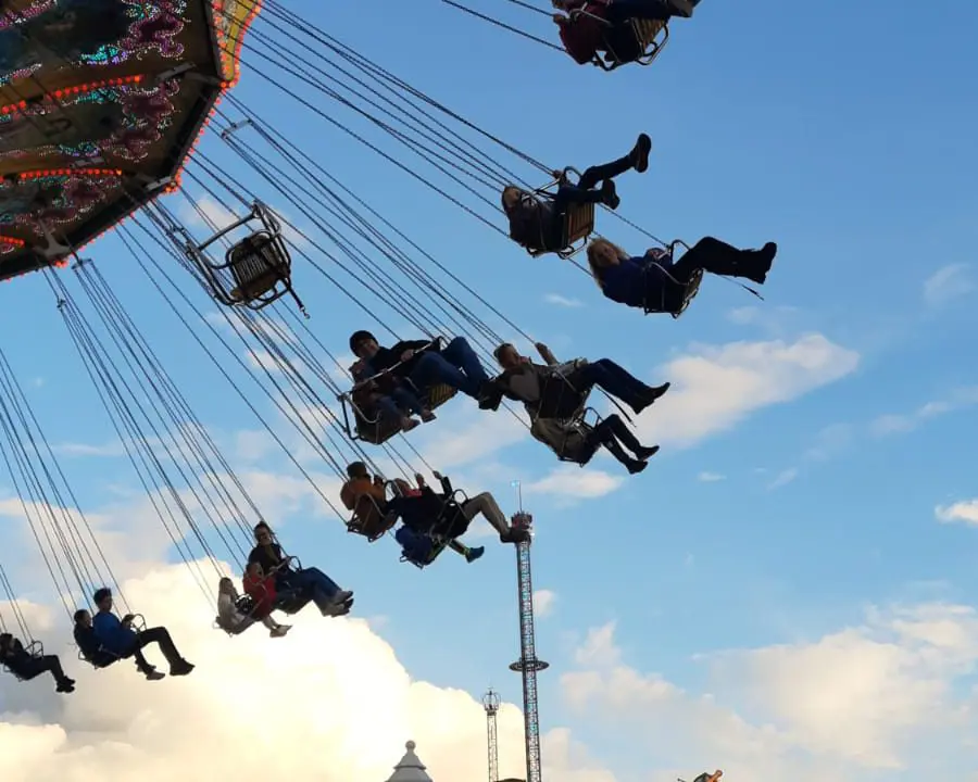Menschen fahren in einem Kettenkarussell.